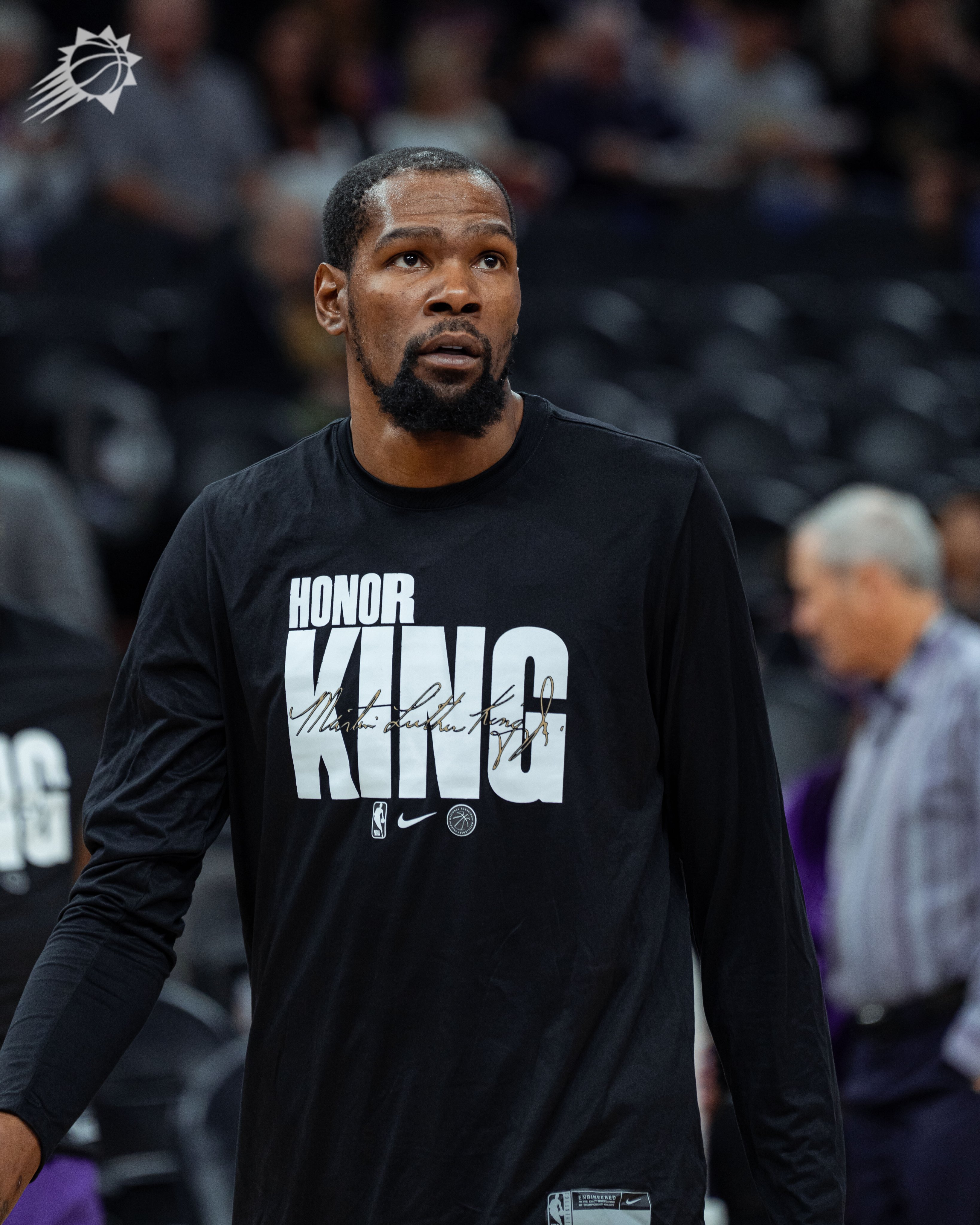 Kevin Durant wearing shirt that says "Honor King" on front.