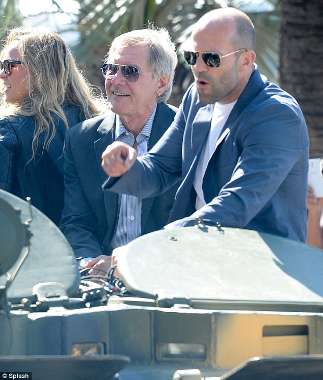 Transporting: British action star Jason Statham, 46, was also seen on the green vehicle sitting next to Ford