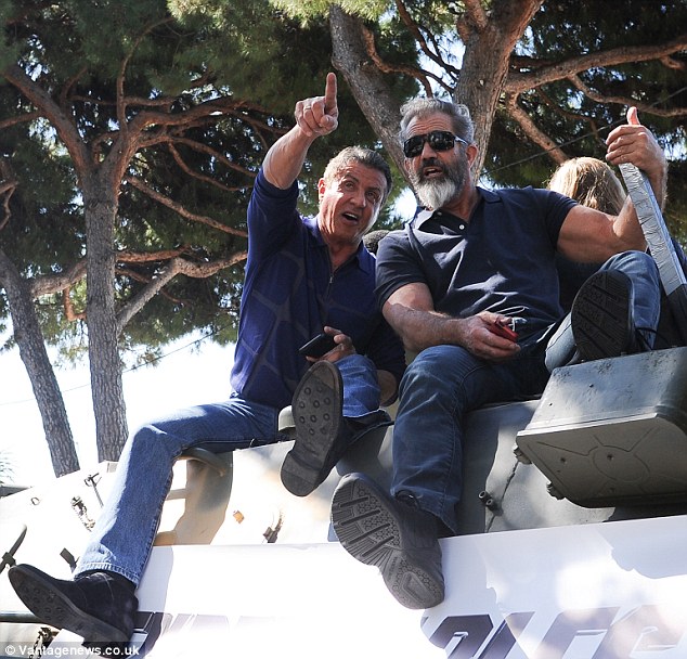 Action-packed: Sylvester Stallone, 67, and 58-year-old Mel Gibson were among the stars of the Expendables 3 who sat atop tanks while making their way through the Promenade de la Croisette at Cannes on Sunday