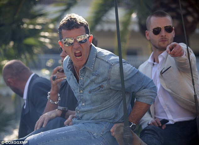 Having fun: The Mask Of Zorro actor appeared to be screaming playfully at the fans and photographers