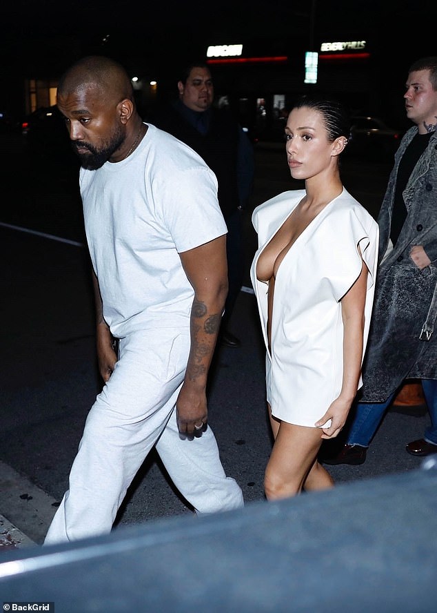 Kanye matched his other half in a white T-shirt an trousers, which he teamed with a pair of tan boots