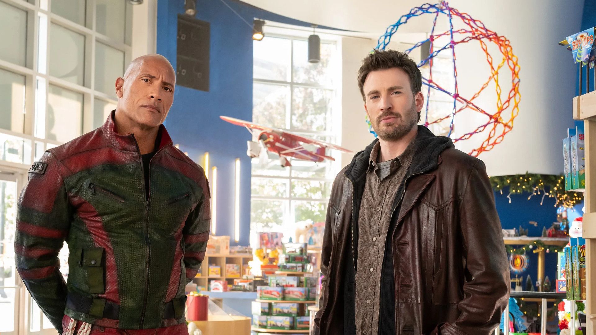 Dwayne Johnson and Chris Evans stand together in Red One
