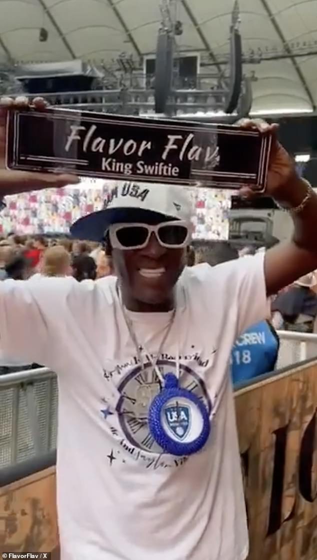 The singer can be seen pointing in his direction and mouthing, 'FLAVOR FLAV!' The musician also shared another clip proudly holding a 'King Swiftie' banner