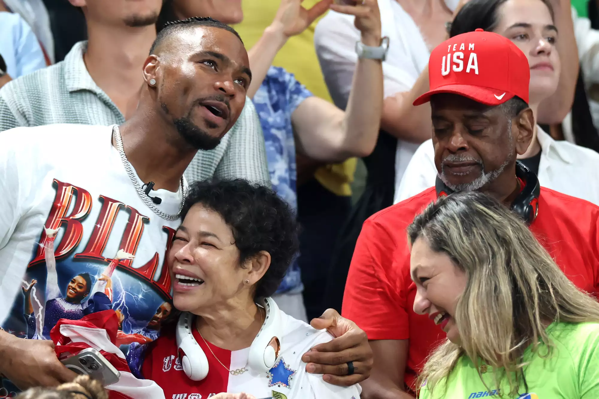 Family members of Simone Biles of Team United States, (L-R) her husband Jonathan Owens and parents Nellie and Ronald Biles celebrate as the Team United States wins the gold medals during the Artistic Gymnastics Women's Team Final on day four of the Olympic Games Paris 2024 at Bercy Arena on July 30, 2024 in Paris, France.